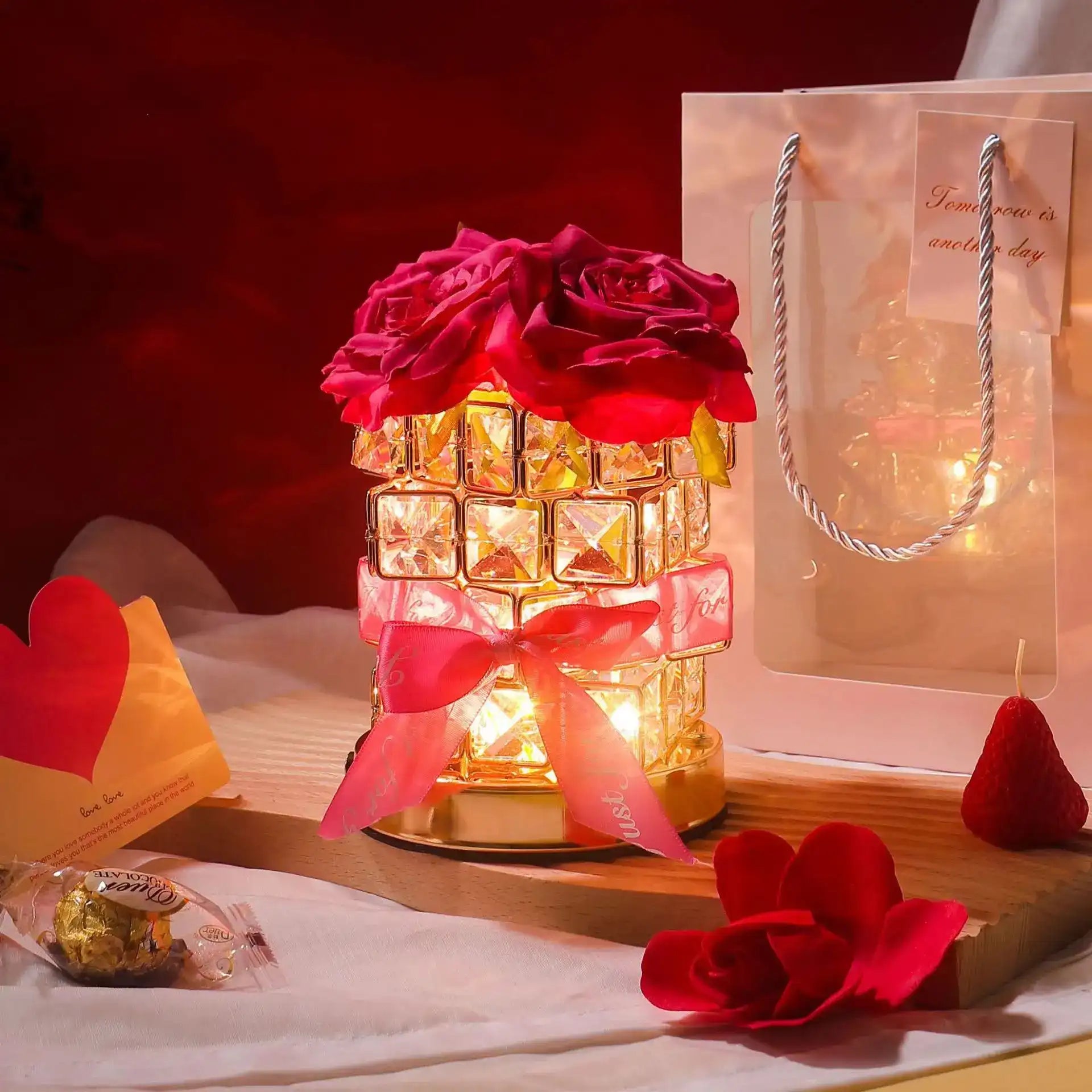 Decorative lamp with roses and a gift bag on a table