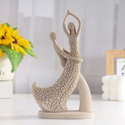 Decorative sculpture of a person in a yoga pose on a white surface with a blurred background