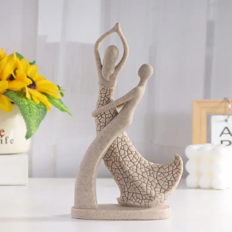 Decorative sculpture of two people embracing on a white surface with a blurred background
