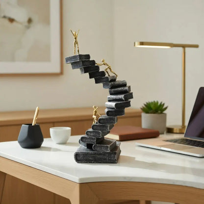 Decorative staircase sculpture on a desk with office items in the background