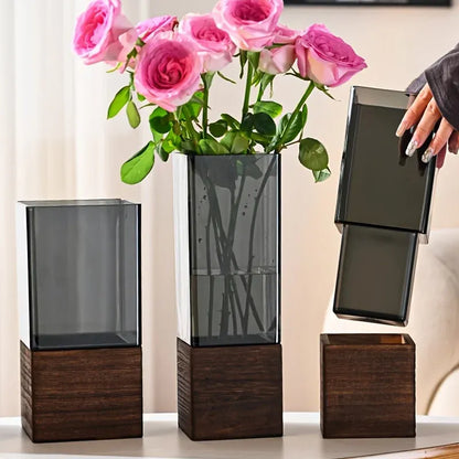 Decorative vase with pink roses on a table with a blurred background