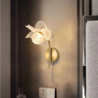 Decorative wall lamp with floral design on a wall.