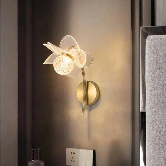 Decorative wall lamp with floral design on a wall.