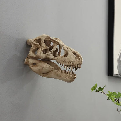 Dinosaur skull wall decoration on a plain wall with a plant in the corner