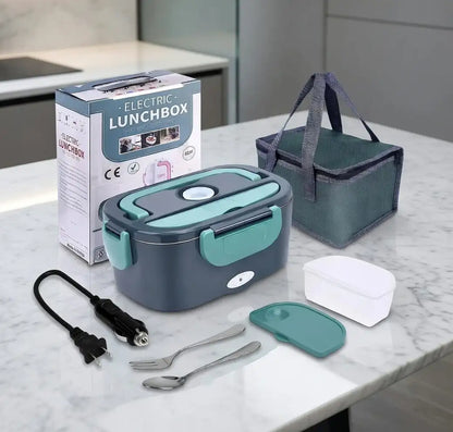 Electric lunchbox set with packaging, power cord, and utensils on a marble surface.