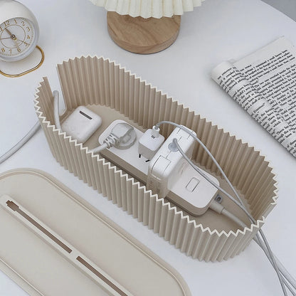 Foldable charging organizer with electronic devices on a white surface