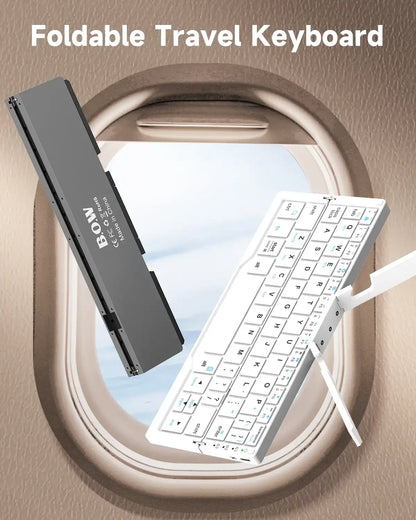 Foldable travel keyboard with a pen on a beige background