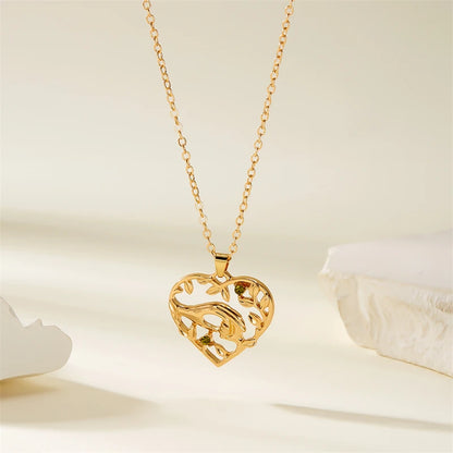 Gold heart-shaped necklace on a soft beige background