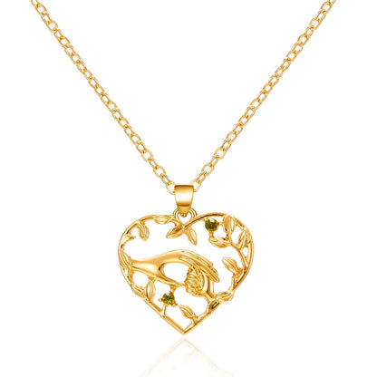 Gold heart-shaped pendant necklace on a white background