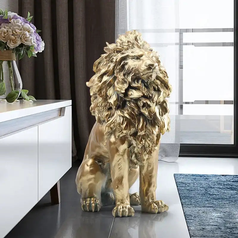 Gold lion statue in a modern living room setting with a white cabinet and decorative flowers.