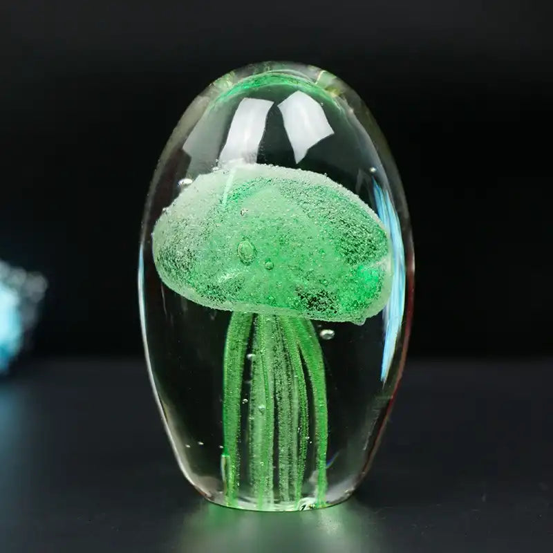 Green jellyfish in a glass dome on a dark background