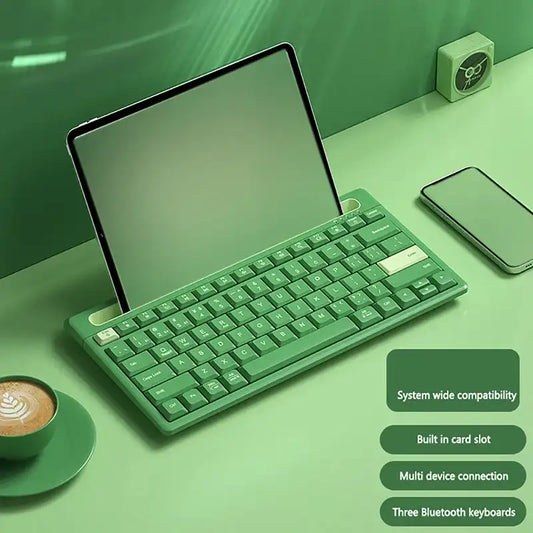 Green keyboard on a green desk with a tablet and smartphone, featuring text about system compatibility and features.
