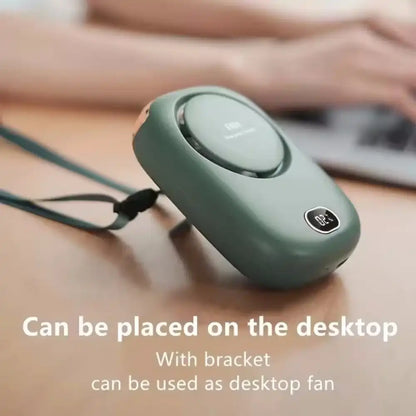 Green portable fan with a bracket on a desk, text indicating it can be used as a desktop fan.