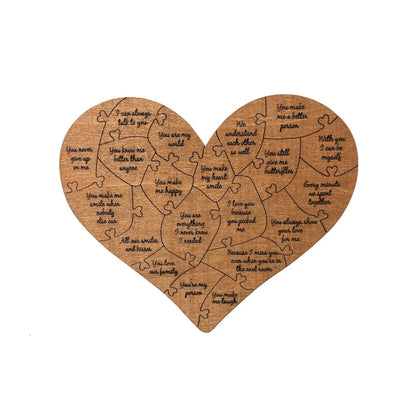 Heart-shaped wooden puzzle with engraved text on a white background