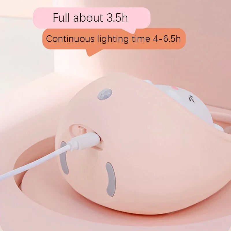 Pink electronic device with a cable, showing battery life information on a light pink background.