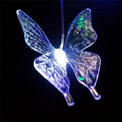 Iridescent butterfly-shaped LED light on a black background