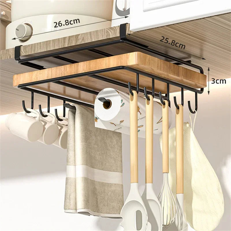 Kitchen organizer with hooks holding utensils and a paper towel roll, mounted under a cabinet.