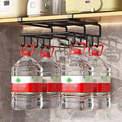 Bottle rack holding four large water bottles under a kitchen cabinet.