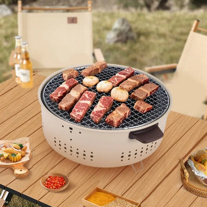 Outdoor setting with a portable grill on a wooden table, featuring food and drinks.