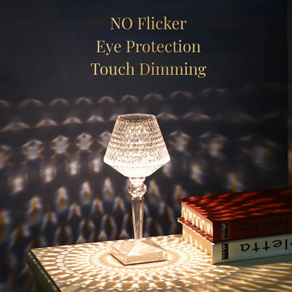 Decorative lamp on a table with books, casting shadows on a textured wall.