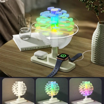 Colorful LED tree-shaped night light on a wooden table with a smartwatch on top.