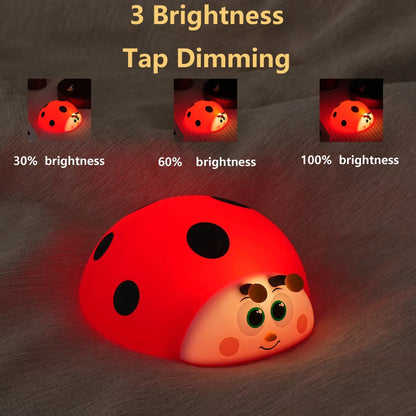 Red ladybug-shaped night light with brightness indicators on a dark background