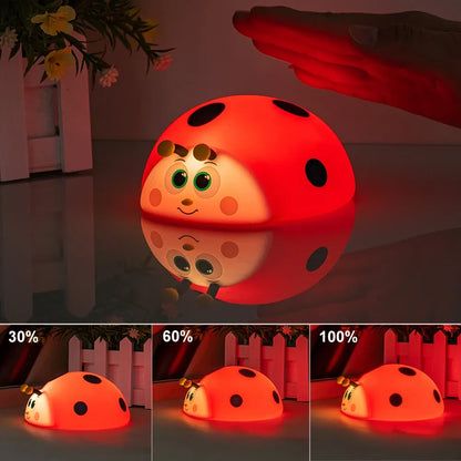 Red ladybug-shaped night light with a hand interacting with it, showing different levels of brightness.