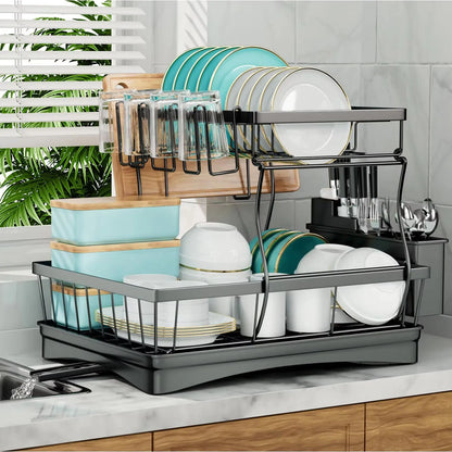 Dish rack with dishes on a kitchen counter, including plates, cups, and glasses.