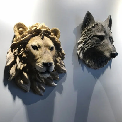 Lion and wolf head sculptures on a white wall