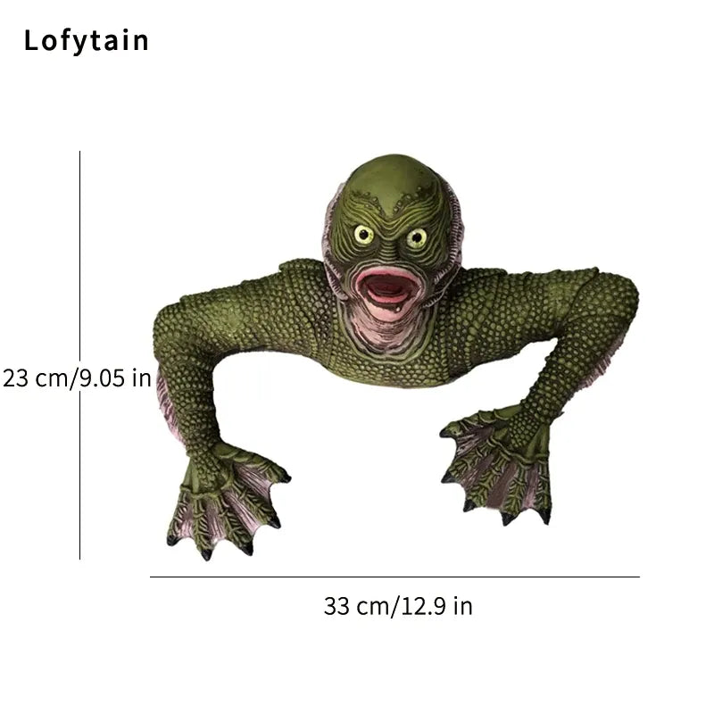 Green creature toy with measurements on a white background