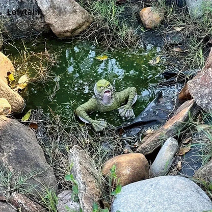 Green lizard in a pond surrounded by rocks and plants