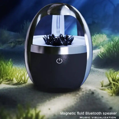 Magnetic fluid Bluetooth speaker with a futuristic design on a natural background