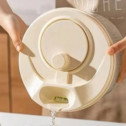 Person holding a beige pet water dispenser with water flowing out.