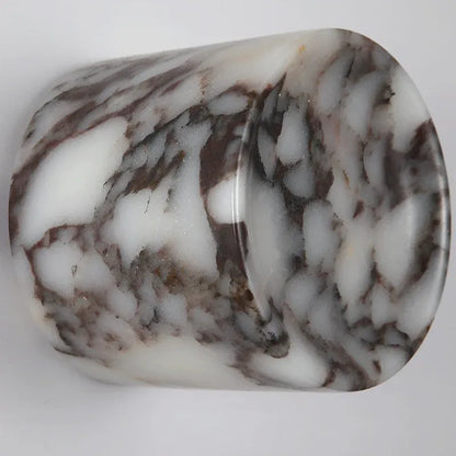 Marbled stone with brown and white patterns on a light gray background