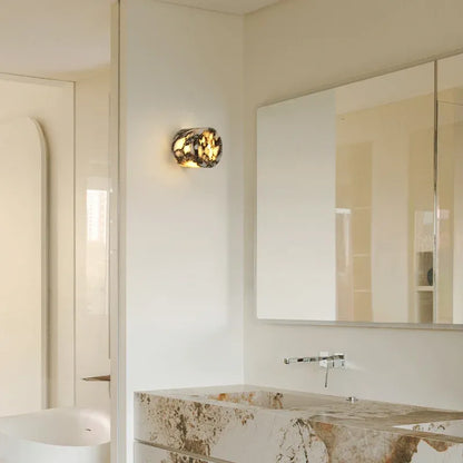 Bathroom interior with a mirror, Marbled stone with brown and white pattern light fixture, and a bathtub.