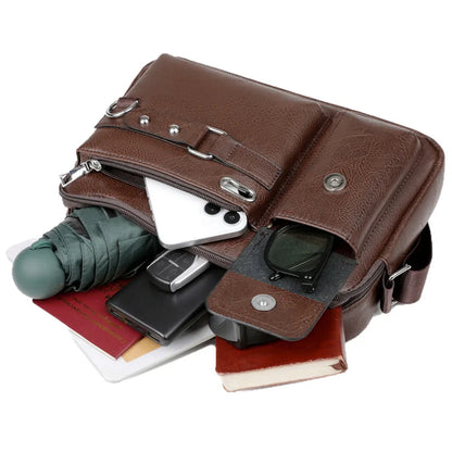 Brown leather multi-compartment bag with various items inside on a white background
