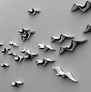 Metallic bird-shaped objects on a gray background