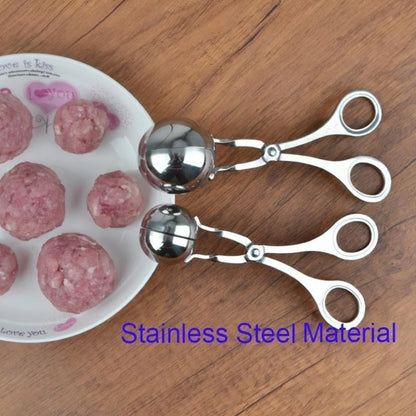 Metallic meatball makers on a wooden surface with ground meat and a white plate.