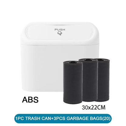 White trash can with a push lid and three black garbage bags on a white background