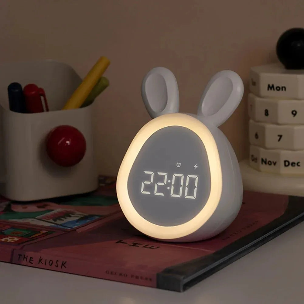 White rabbit-shaped night light with digital display on a desk