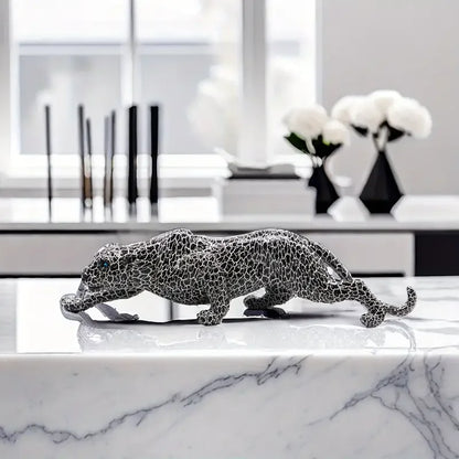 Decorative leopard sculpture on a marble surface with a modern interior background