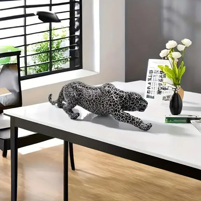 Decorative leopard on a table with a vase and flowers in a modern office setting