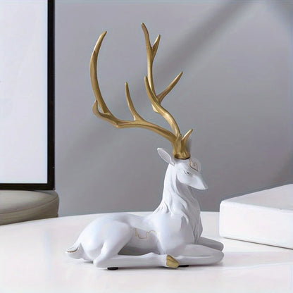 Decorative deer figurine with gold antlers on a white surface