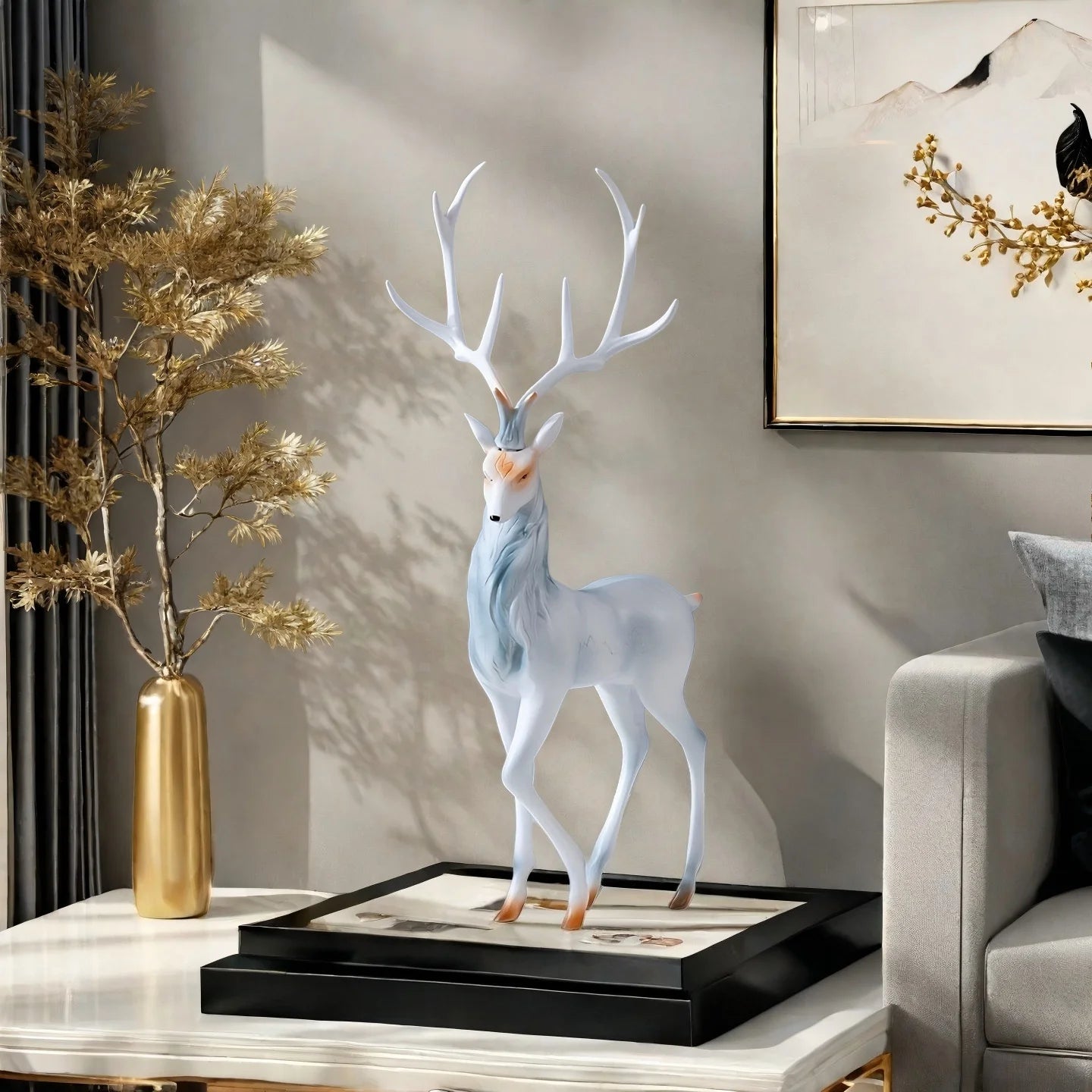 Modern Deer Sculpture on a table with a gold vase and plant in a living room setting.