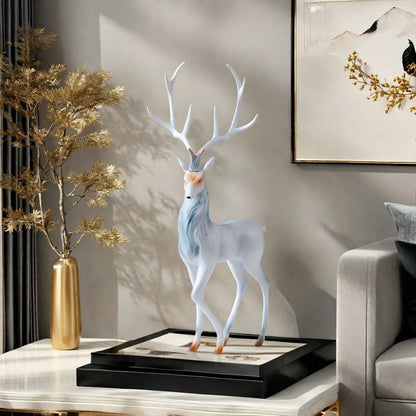 Modern Deer Sculpture on a table with a gold vase and plant in a living room setting.