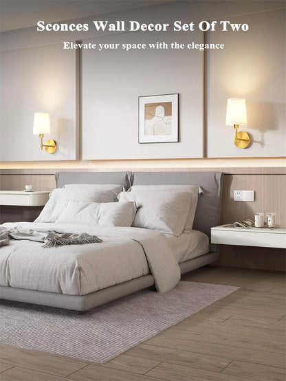 Modern bedroom with wall sconces and decor, featuring a bed and side tables.