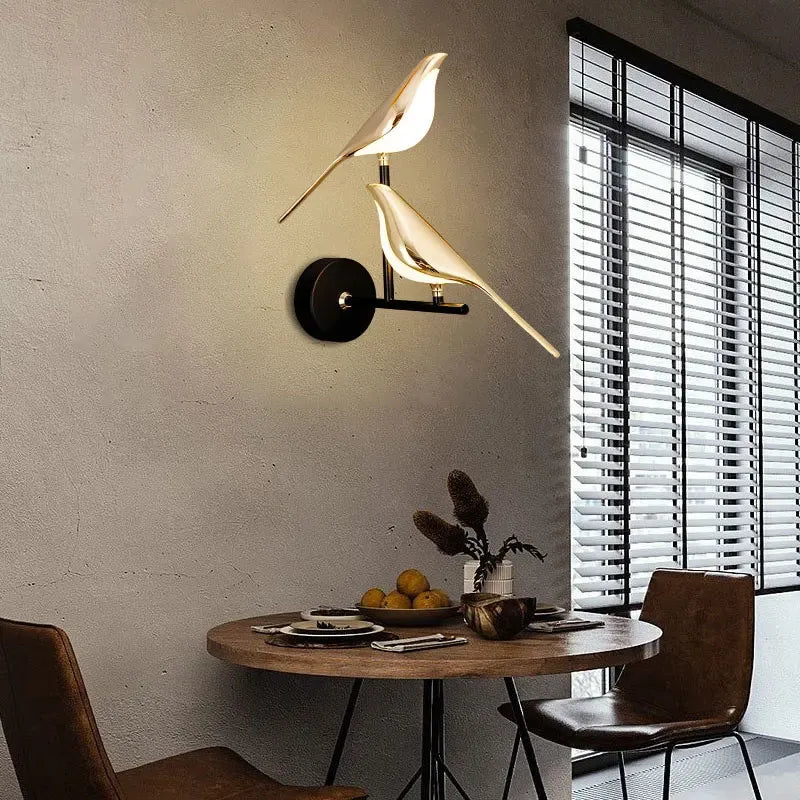 Modern bird wall lamp in a dining room setting with a table and chairs.
