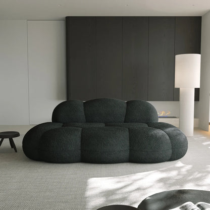 Modern black sofa in a minimalistic living room with neutral colors.