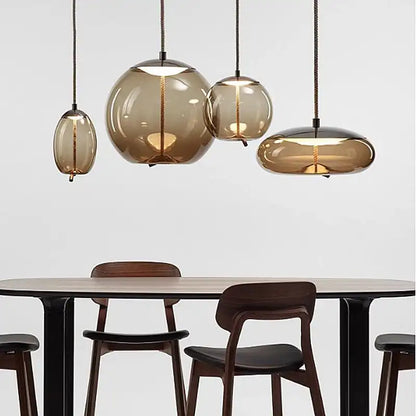 Modern dining table with glass pendant lights on a white background