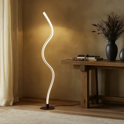 Modern floor lamp with curved design in a room setting.